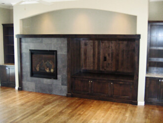 Livingroom fireplace with custom dark wooden built in
