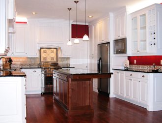 Kitchen with white cabinets and dark wooden island